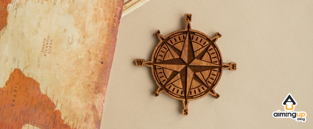 Compass crest beside a map.